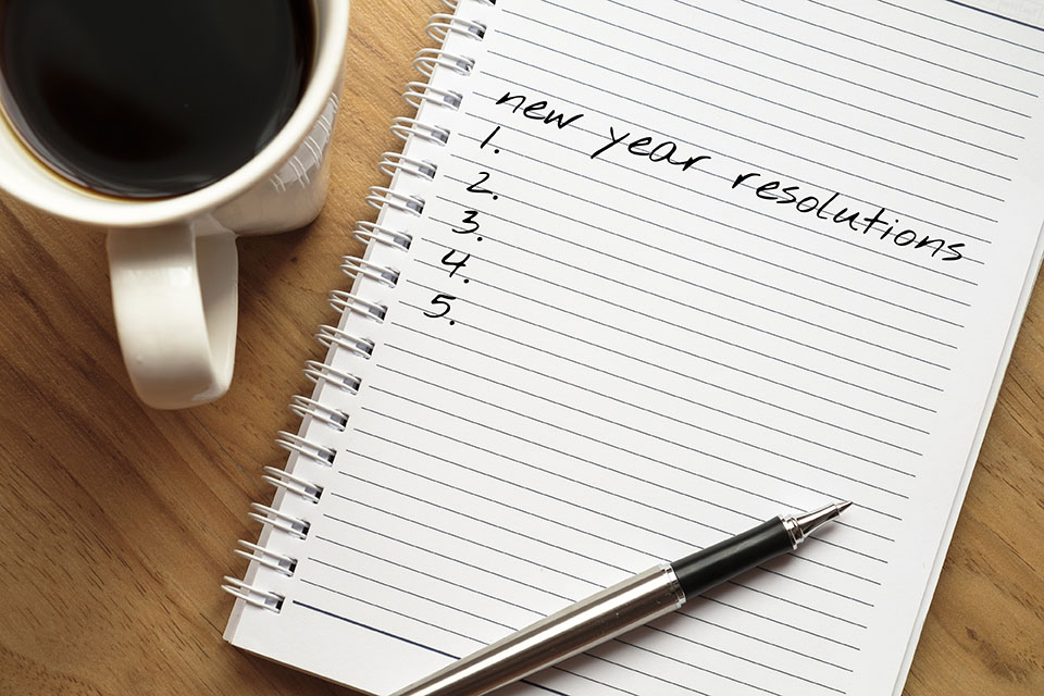 Writing out New Year's Resolutions for your small business that will also help you save on energy