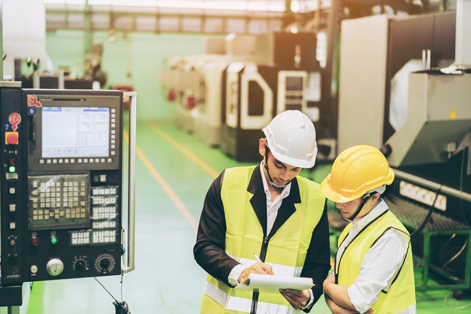 Two engineers making plans for their facility