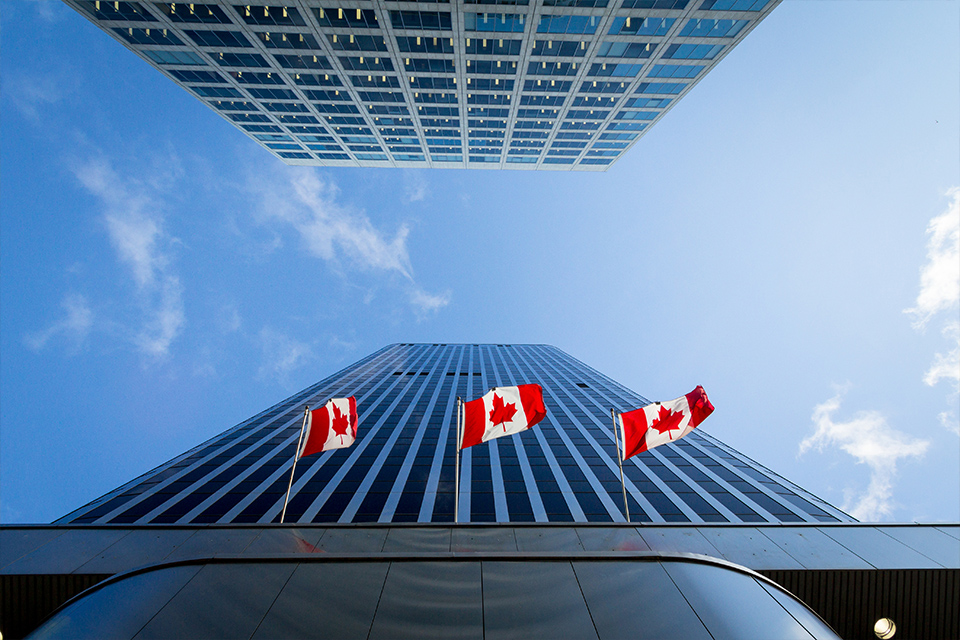 Buildings with three Canadian flags