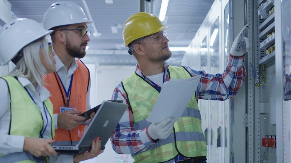 engineers examining equipment