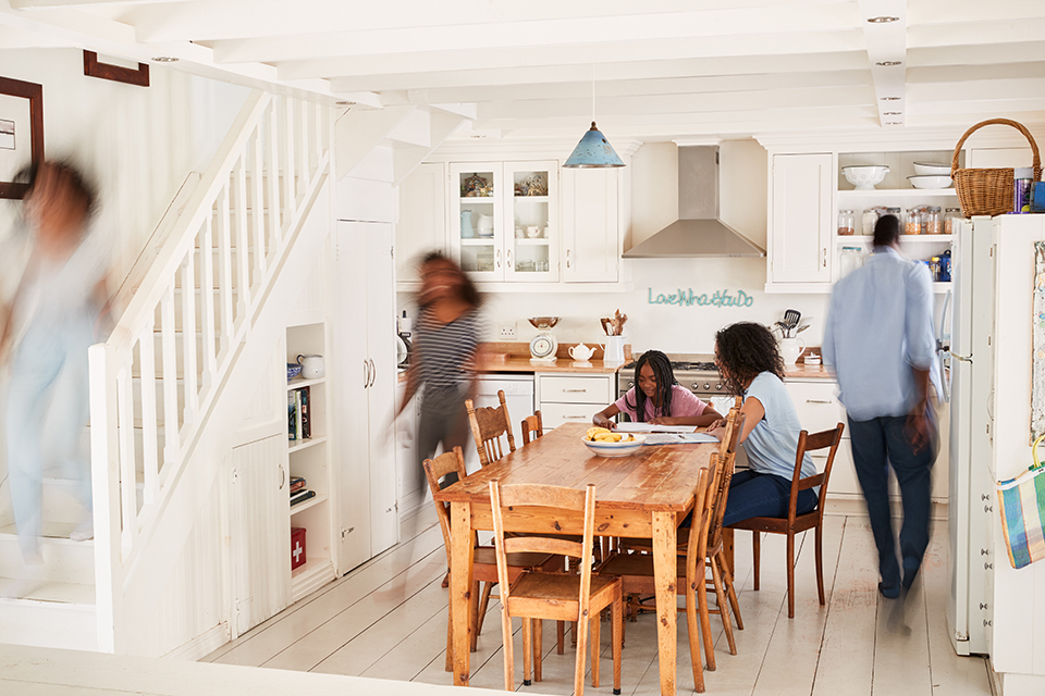 family bustling around their kitchen before work and school