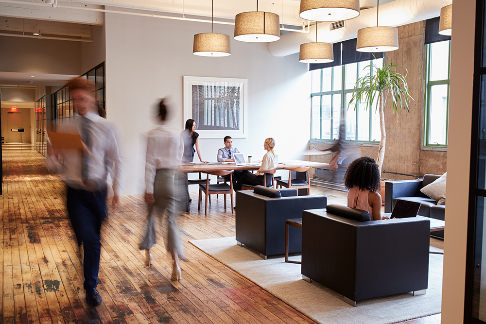 Employees bustling about in energy-efficient office building