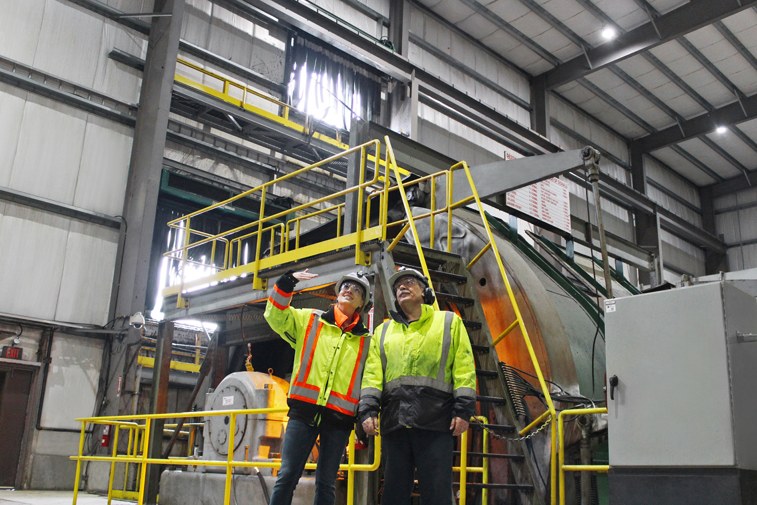 Two employees discussing efficiency of equipment at GoldCorp