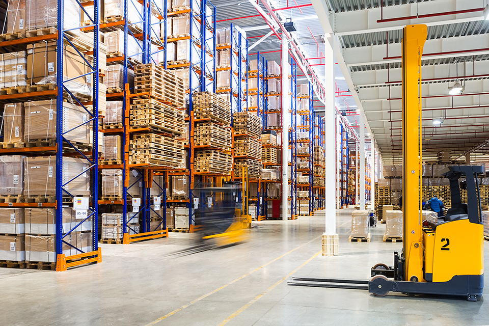 large modern warehouse with forklifts