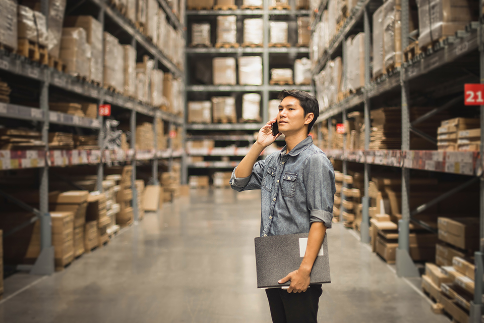 man on cell phone in warehouse