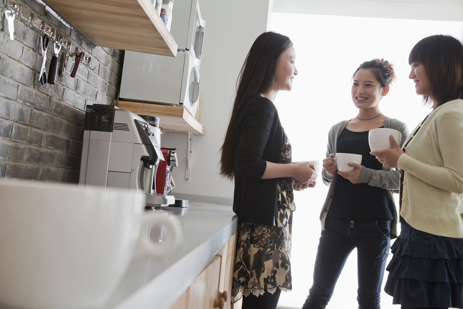 colleagues conversing in an efficient office kitchen